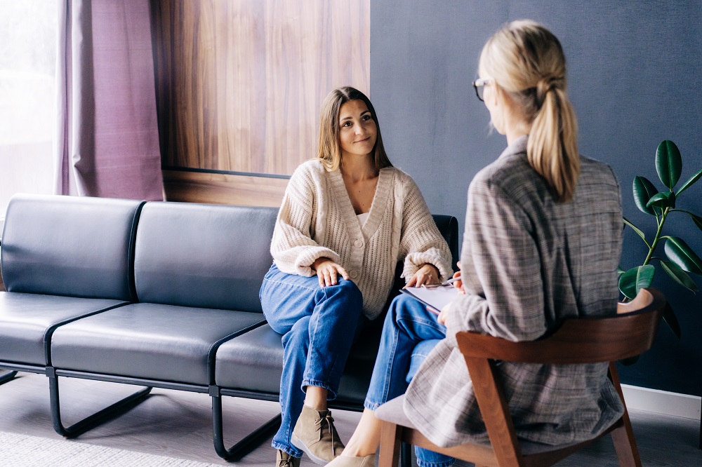 A smiling client is having a confidential conversation with a co