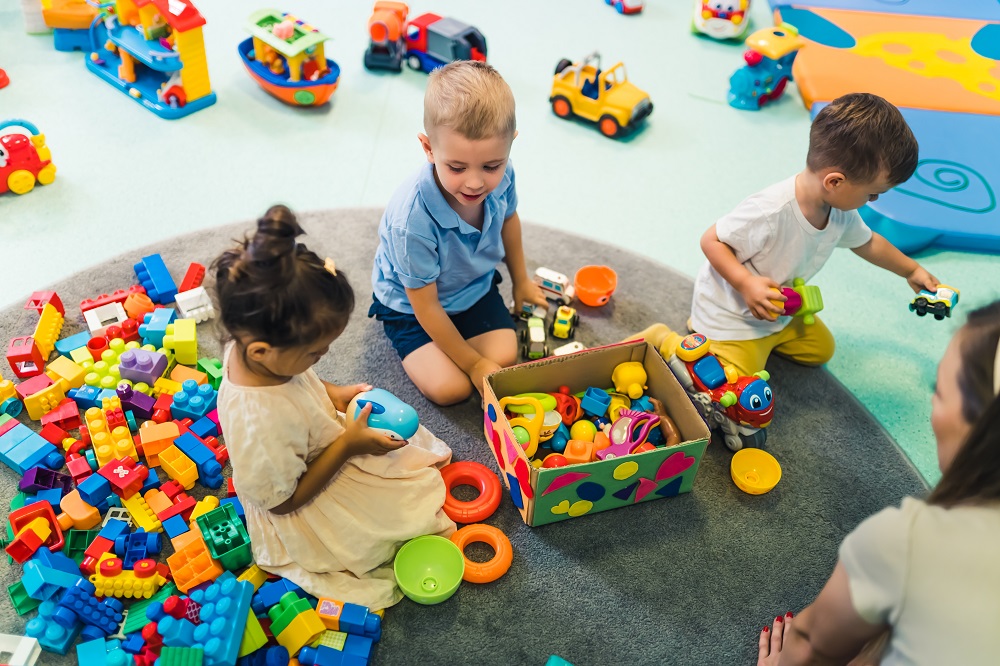 Preschoolers playing with building blocks and toys at daycare